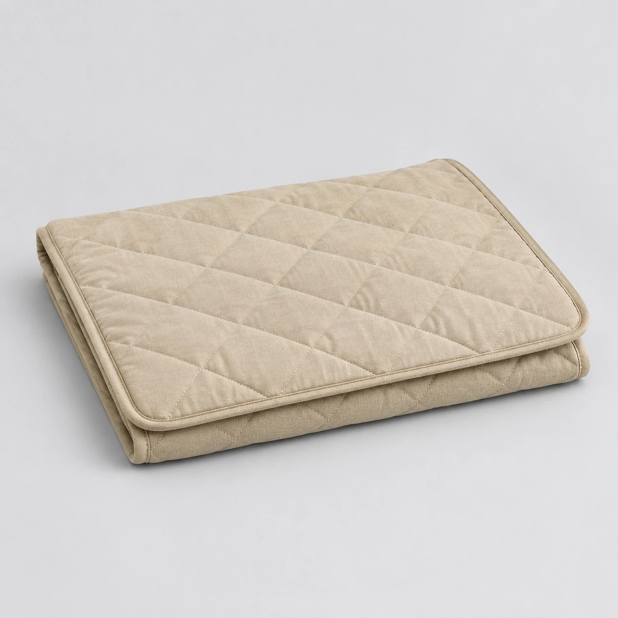 Quilted crate mat folded on a neutral background