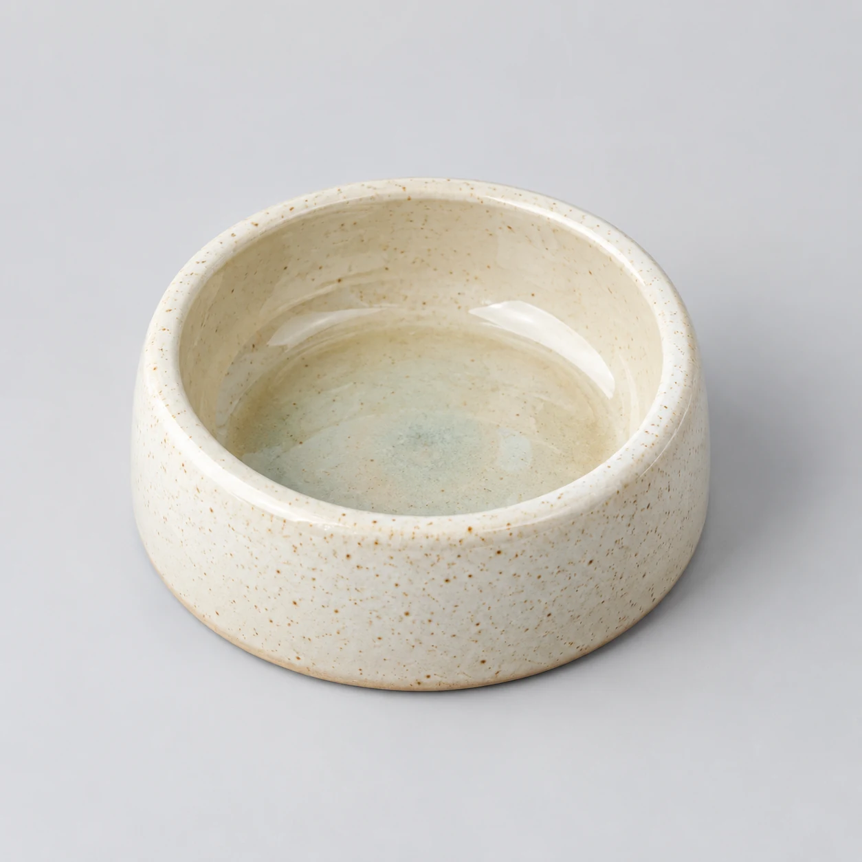 Glazed stoneware pet bowl photographed on a neutral background