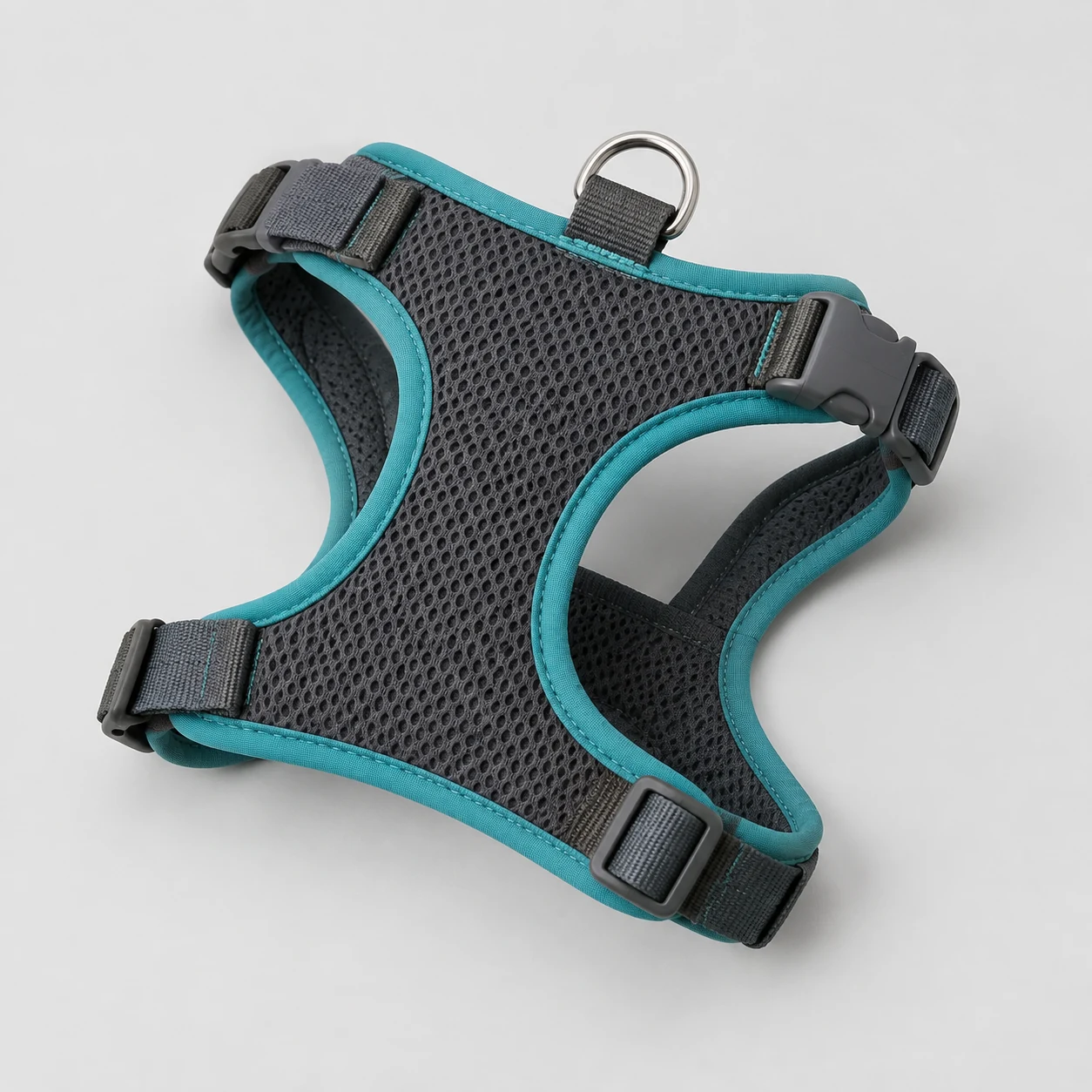Padded mesh dog harness with adjustable straps on a neutral background