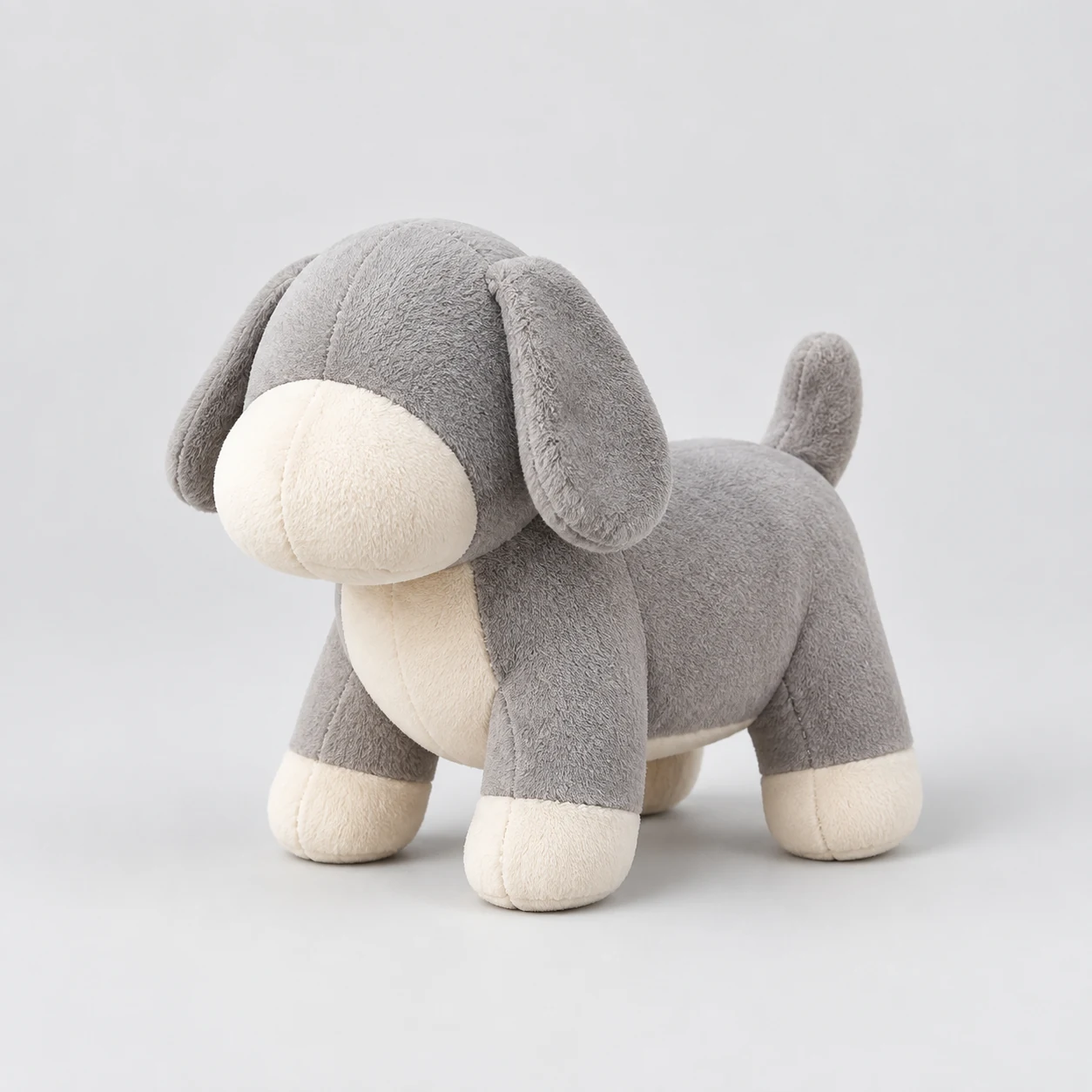 Soft plush dog toy with stitched seams on a neutral background